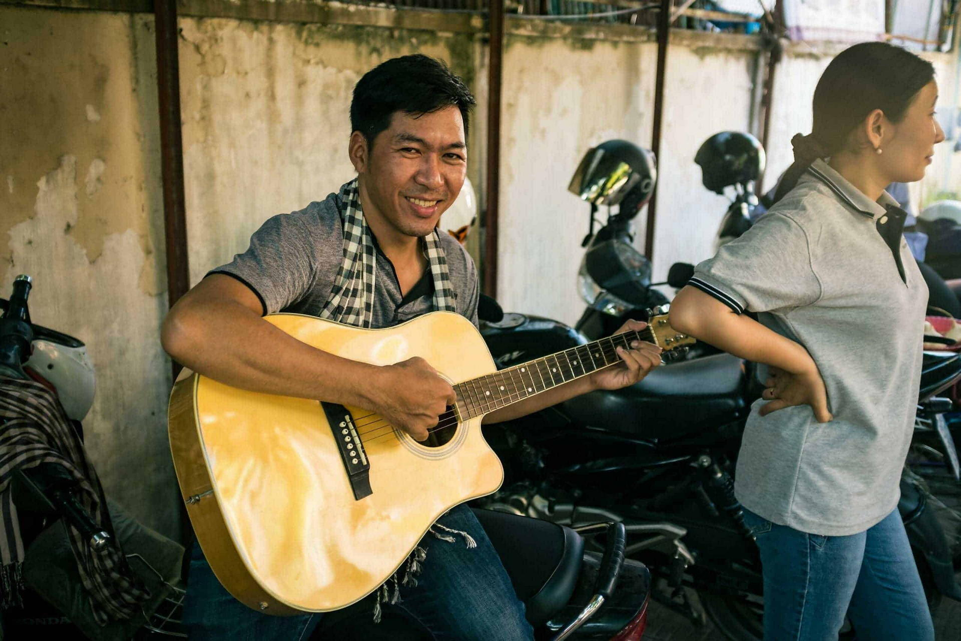 Konthea plays guitar as part of Children in Families church partnership program
