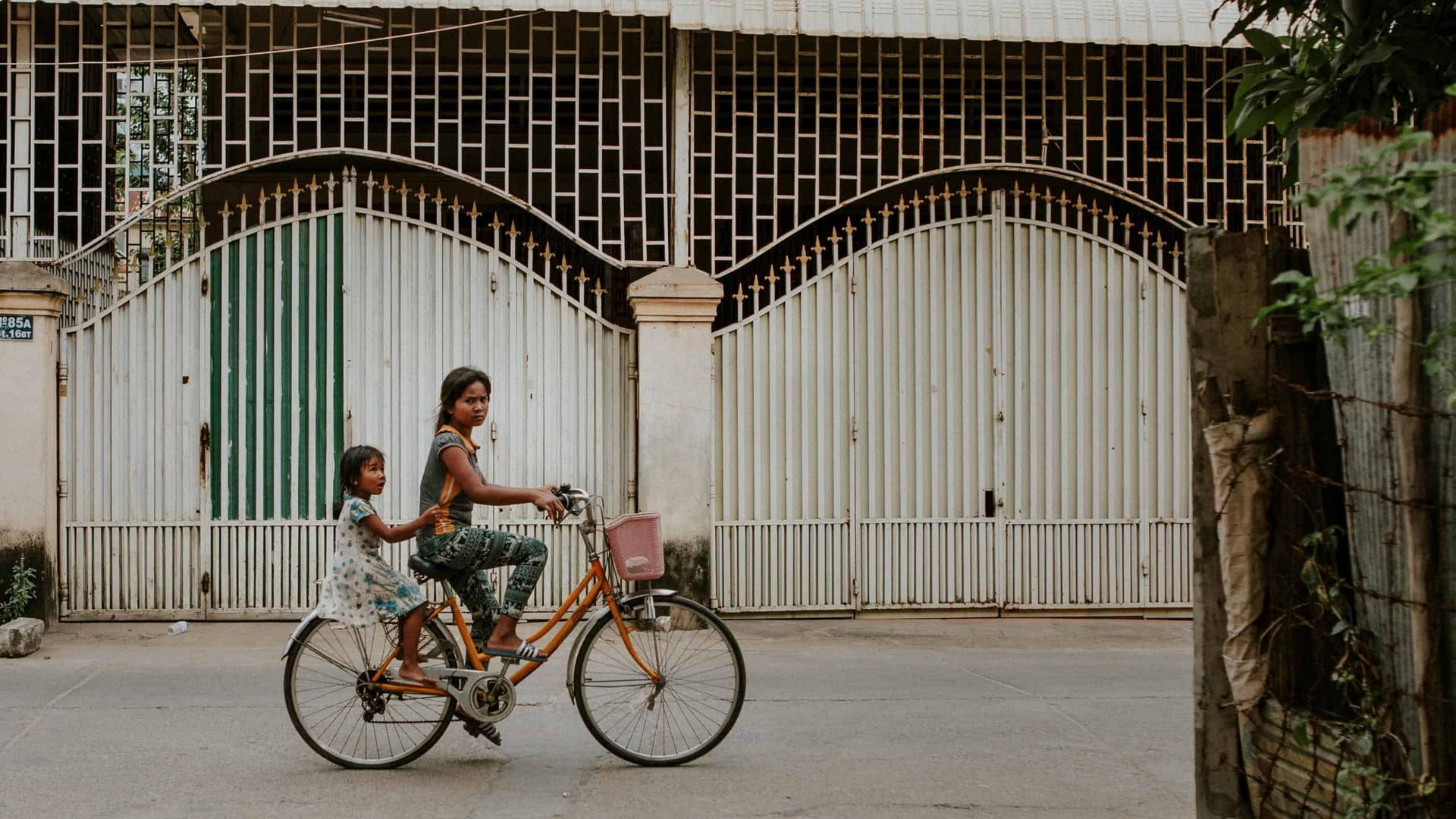two cambodian girls on a bicycle together in Phnom Penh Cambodia